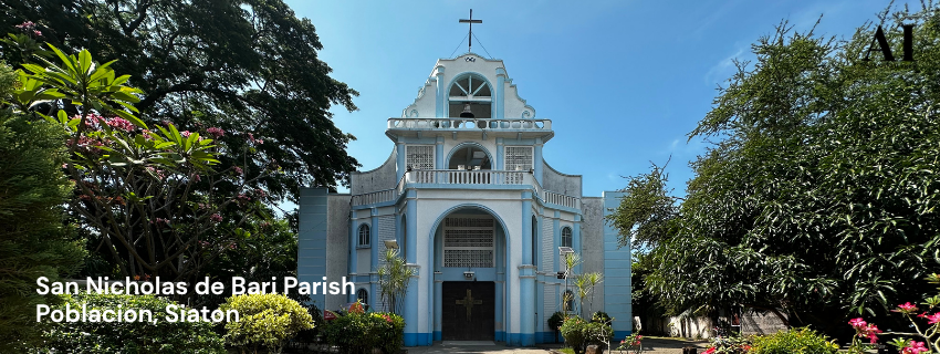 Featured image of St. Nicholas of Bari Parish in Poblacion, Siaton, Negros Oriental, showing the blue and white facade with text overlay against a lush green garden.